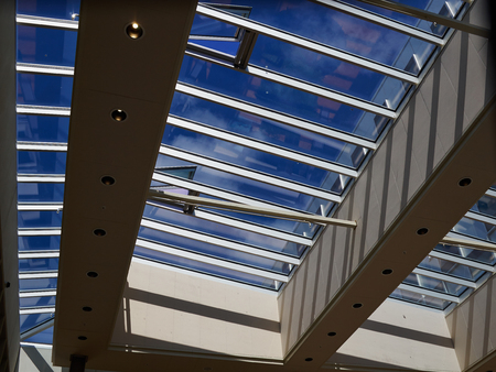 Glass roof of modern building with background of clear blue sky
