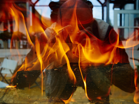 Burning modern trendy design firplace made of steel and glassの写真素材