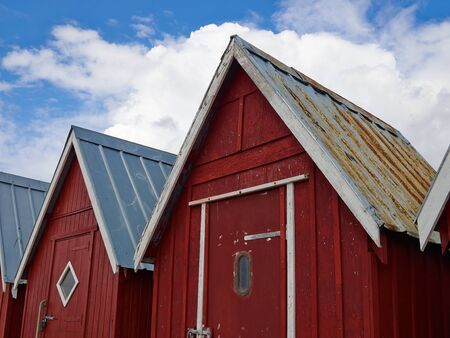 Beautiful red fishing huts on the coast Faaborg Denmarkの写真素材