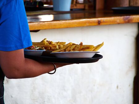 Tasty fresh chips French Fries potatoes served to the table