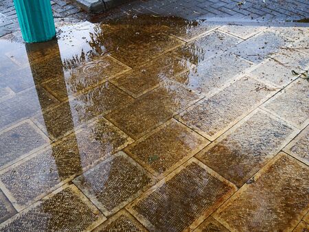 Reflection of the surrounding in a puddle after the rain