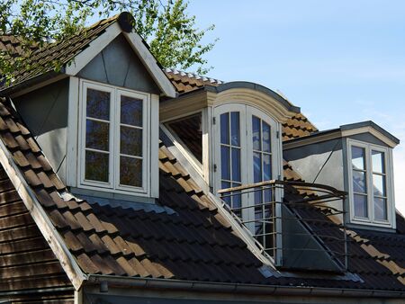Modern design vertical roof window with white light metal covering                                  ...