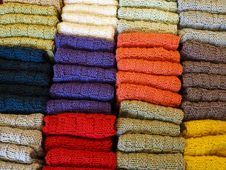 Closeup view of a creative traditional collection of colorful handmade knitted wool winter socks