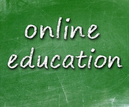 Online education school written on a chalkboard                   の写真素材