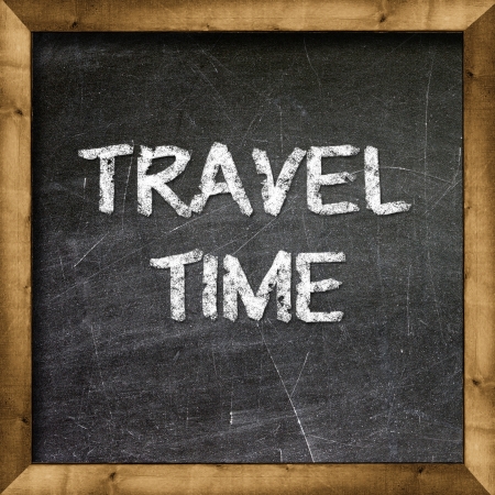 Travel Time handwritten with white chalk on a blackboard の写真素材