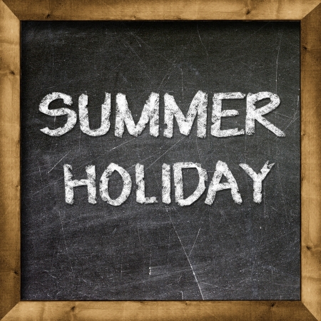 Summer Holiday handwritten with white chalk on a blackboard の写真素材