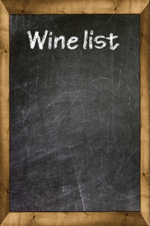 Wine list written with white chalk on a blackboardの写真素材
