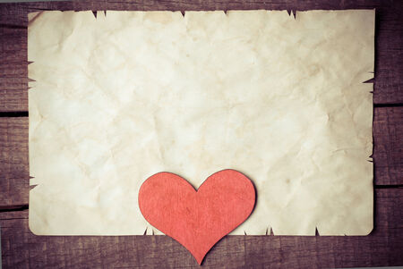 Wooden heart on old paperの写真素材