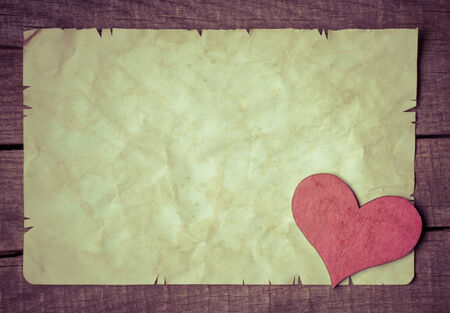 Wooden heart on old paperの写真素材