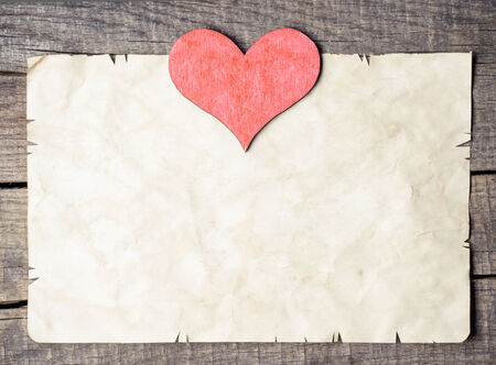 Wooden heart on old paperの写真素材