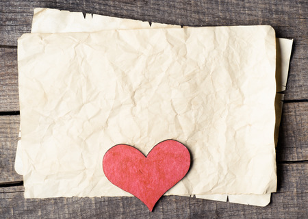 Wooden heart on old paper の写真素材