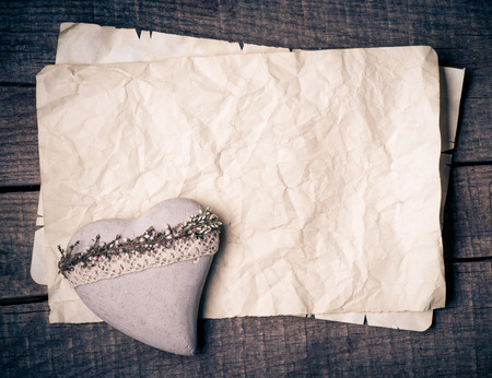 Wooden heart on old paper の写真素材