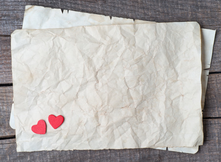 Wooden heart on old paper の写真素材