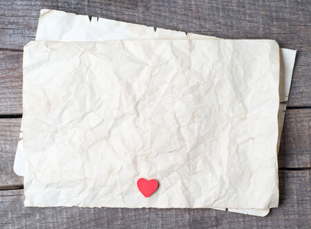 Wooden heart on old paper の写真素材