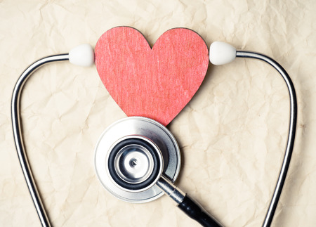 Heart and stethoscope on old paper texture の写真素材