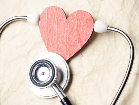 Heart and stethoscope on old paper texture の写真素材