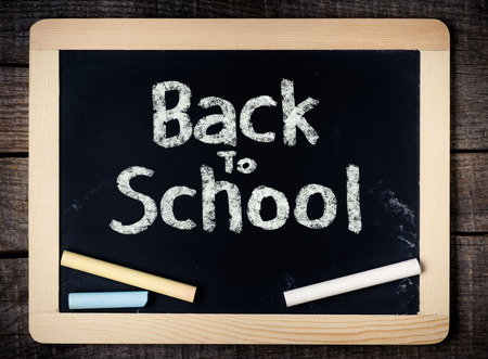 Back to School handwritten on blackboard with chalk on wooden background の写真素材