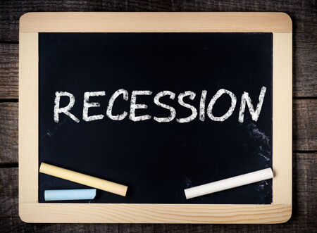 Blackboard Showing Recession on wooden background の写真素材