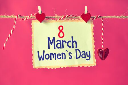 8  march Women's Day on paper , hanging on a rope with red heartsの写真素材
