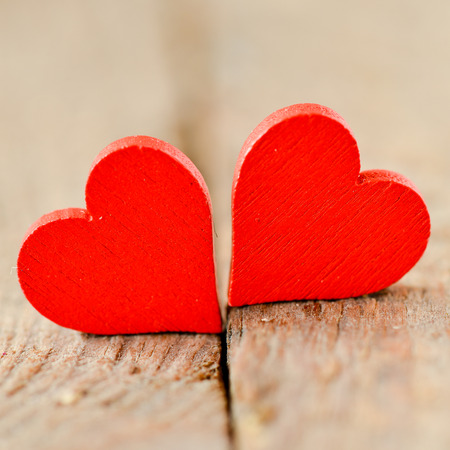 Hearts on a wooden background. Background in the style of Valentine's Day. Heart on a wooden backgroundの写真素材