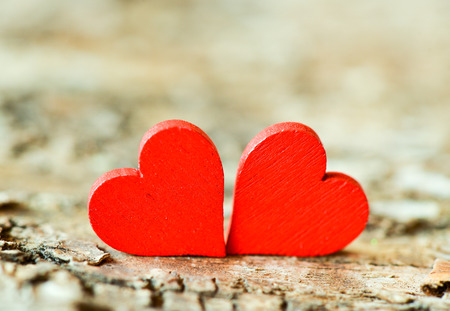 Hearts on a wooden background. Background in the style of Valentine's Day. Heart on a wooden backgroundの写真素材