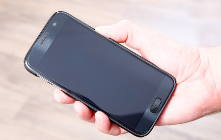 hand holding a smartphoneの写真素材