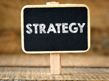 Strategy. Business concept on blackboard on wooden backgroundの写真素材