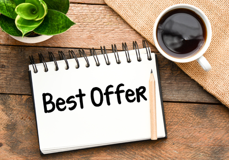 Best offer inscription, plant and coffee cup on wooden backgroundの写真素材