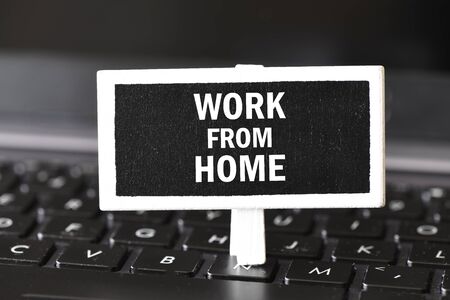 Work from home word written on a small chalk board. Business concept. Time for remote work at home.の写真素材