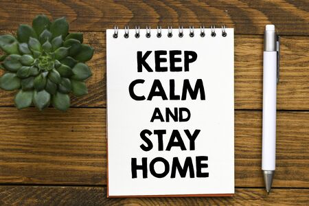 Keep calm and stay home text on note with penの写真素材