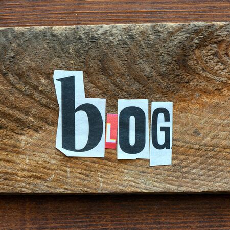 BLOG Word blog composed of letters spelled from the press on wooden background.の写真素材