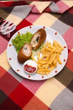 cutlet by Kiev with french fries ketchup mayonnaise
