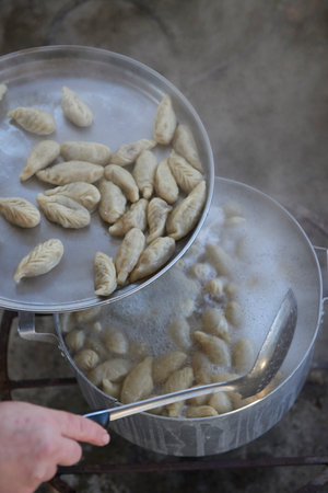 A dish of Azerbaijani national cuisine called Gyurza with deer meat from hunting meat and dough complete cooking step by step from start to finish part final ready dumplingsの写真素材