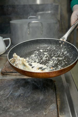 Roasting mushrooms in a boiling pan with cream professional chef