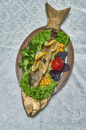 well-done trout on a bronze copper dish