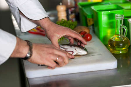 The chef prepares dorado fish