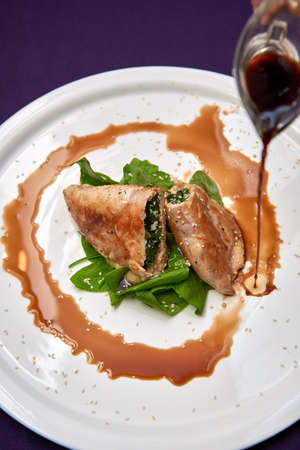 Pie with spinach and sweet and sour sauceの写真素材