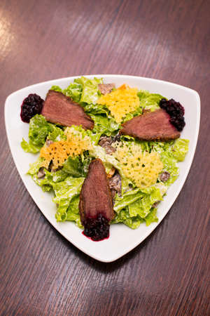 Baked beef with garnish salad mushrooms cheeseの写真素材