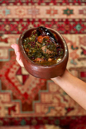 Meat baked in earthenware bright with vegetables and herbs cooking with garnish National cuisine of Azerbaijanの写真素材