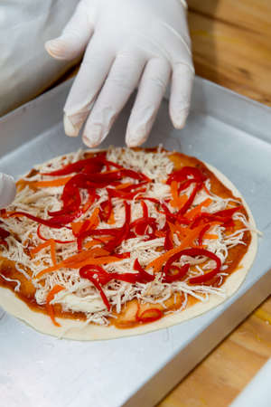 Confectioner chef coocking for baking pizza hands working momentの写真素材