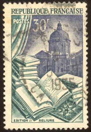 The scanned stamp. It is a lot of books against a building.の写真素材