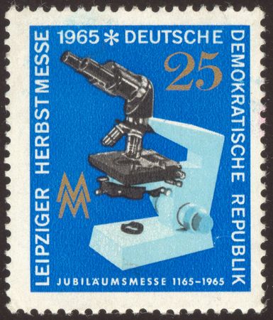 The scanned stamp. German stamp. Microscope in laboratory. Biological researches.の写真素材