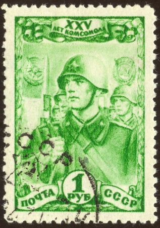 The scanned stamp. The Soviet stamp. Soldiers march. Soldiers with rifles and bayonets.のeditorial素材
