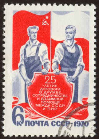 The scanned stamp. Soviet stamp. Two workers against flags.の写真素材