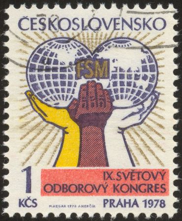 The scanned stamp. Chehoslovatsky stamp. Hands hold a planet the Earth.の写真素材