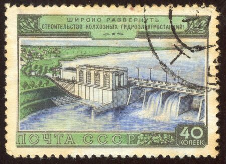 The scanned stamp. The Soviet stamp. Hydroelectric power station in a village place.の写真素材