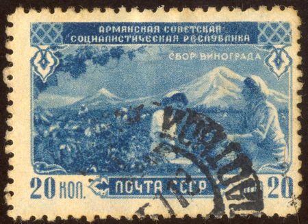 The scanned stamp. The Soviet stamp. Farmers reap grapes crop.のeditorial素材
