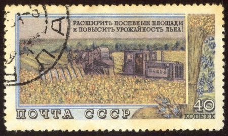 The scanned stamp. The Soviet stamp. Collective farmers plough a field.の写真素材