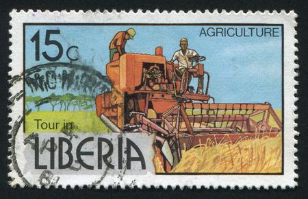 LIBERIA - CIRCA 1976: The combine reaps wheat crop, circa 1976.の写真素材