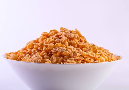 Goldish corn flakes. Macro with extremely shallow dof. Close-up of cornflakes.